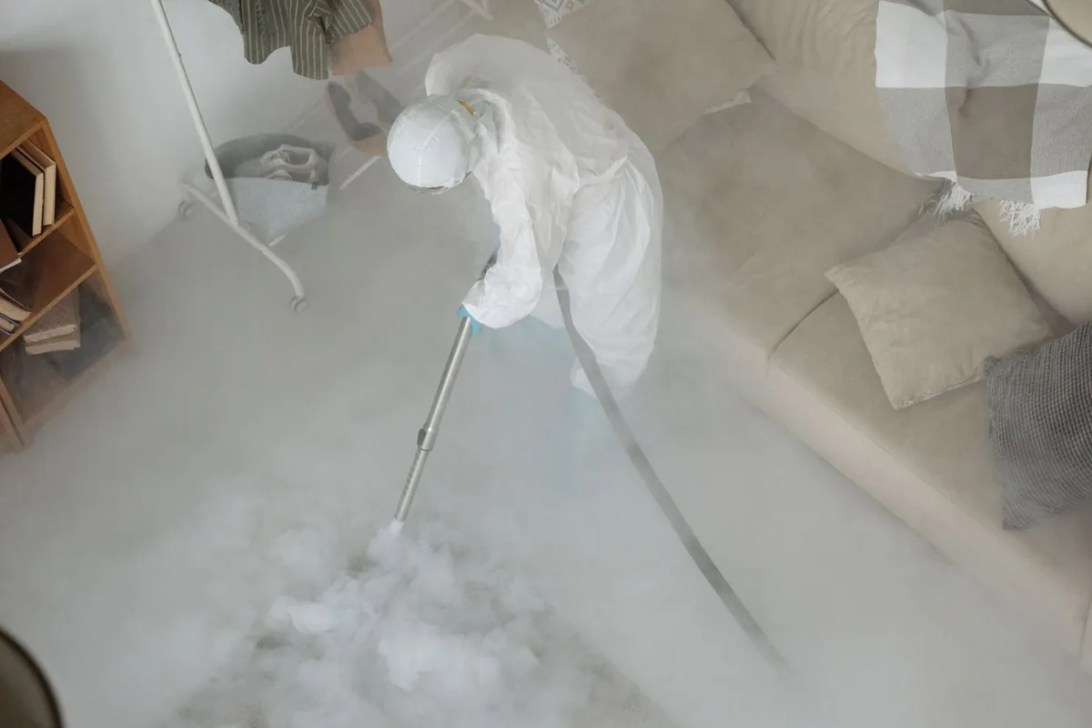 Biohazard cleanup technician in protective equipment, Glasgow Village, MO